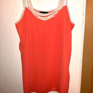 Coral orange asymmetrical sheer strappy top.